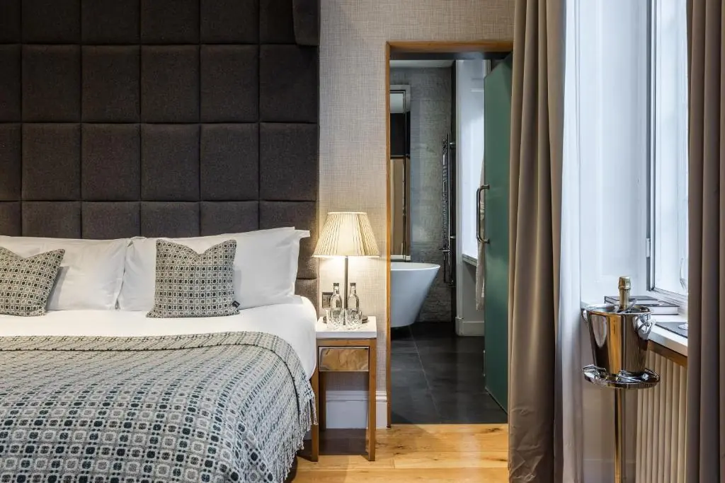 One of The Inn on the Mile's luxury bedrooms, featuring a double bed and en-suite bathroom.
