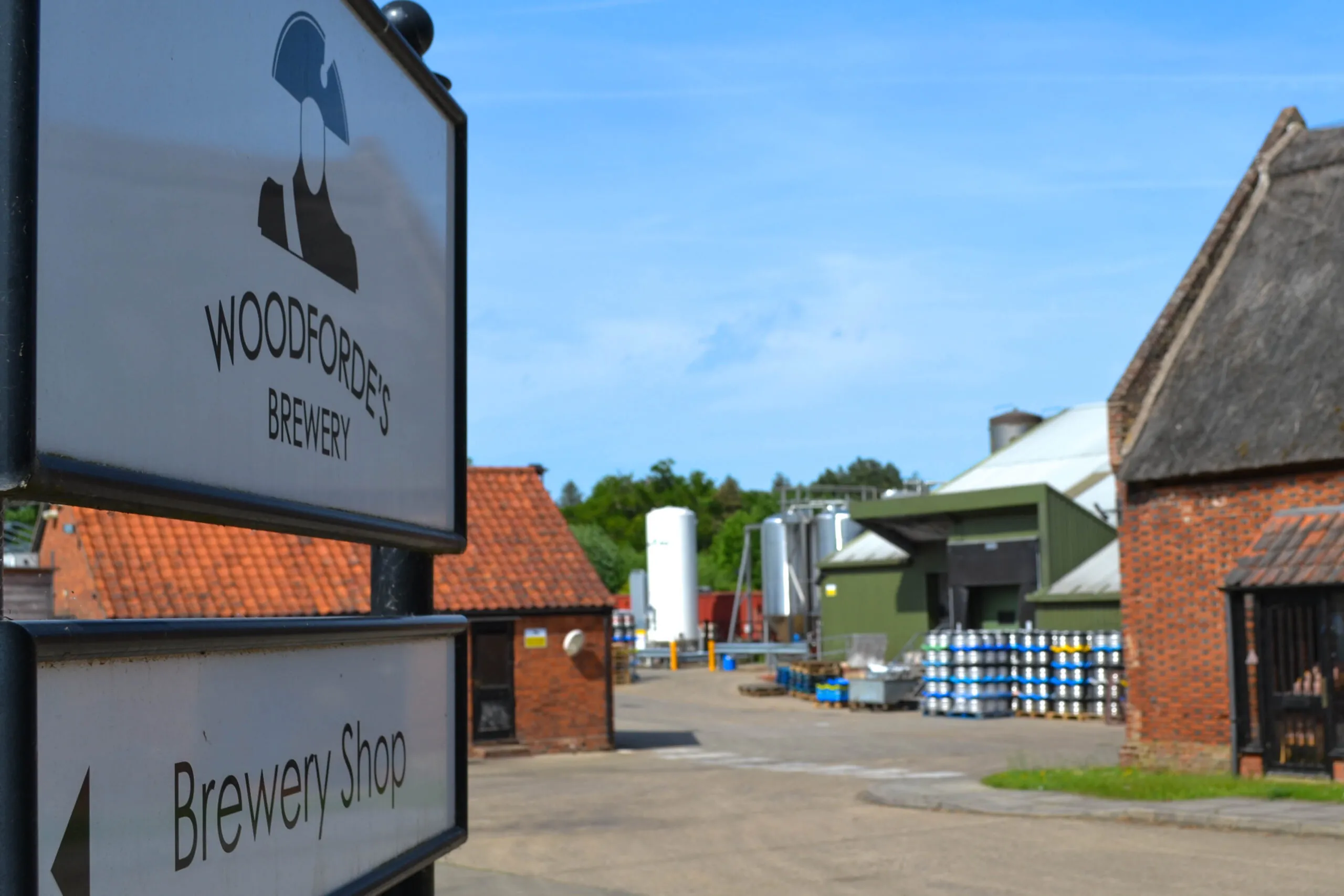 Exterior of Woodfordes Brewery featuring the brewery's sign