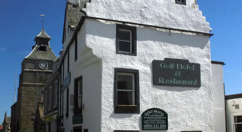 A pretty white building with a black sign stating 'Golf Hotel & Restaurant'